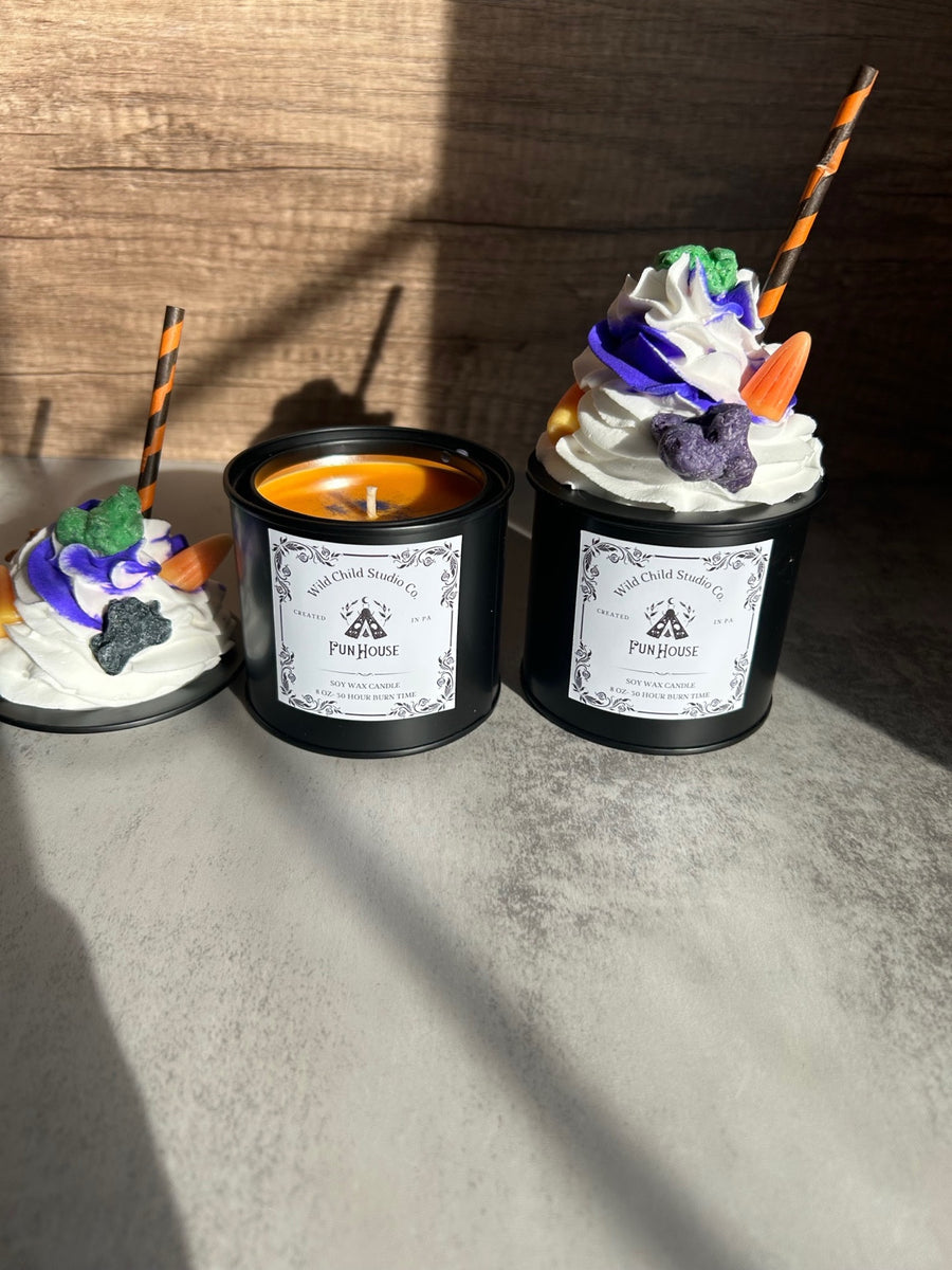 Fun House candles with orange wax and decorative whipped lids